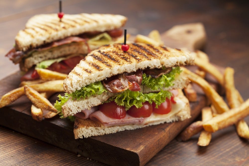 Tasty club sandwiches and french fries.