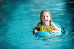 little girl swimming in a pool